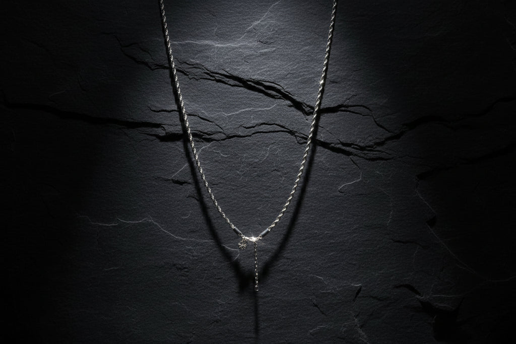Silver necklace on a white mannequin bust with a blurred indoor background